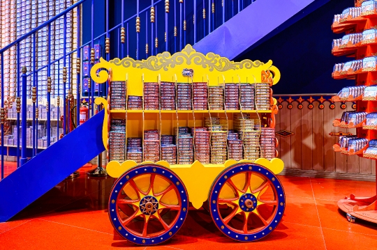 A decorative retail display cart full of sardine cans inside the