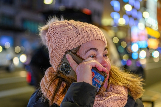 A female tourist speaking in smartphone in the Gran Via, Madrid,