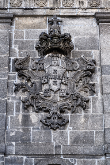 Ancient coat of arms on a medieval stone wall in the Ribeira Dis