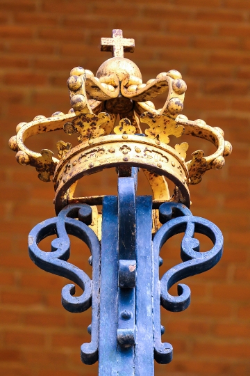 Ancient decorative metalwork of a royal crown on the fence of th