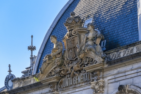 Ancient stone coat of arms and sculptures on a building known as