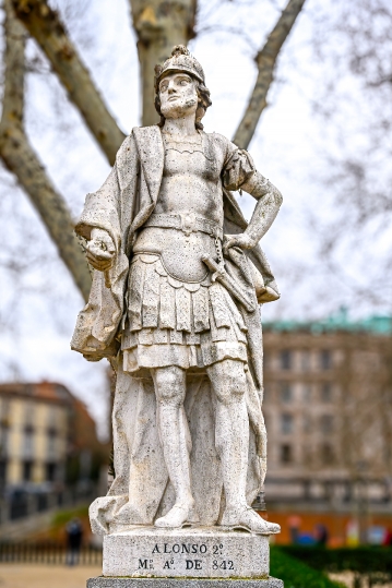 Ancient stone statue of Alfonso II in the gardens across the Roy