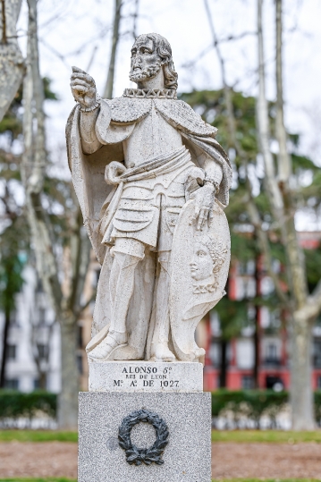 Ancient stone statue of Alfonso V King of Leon in a public park,