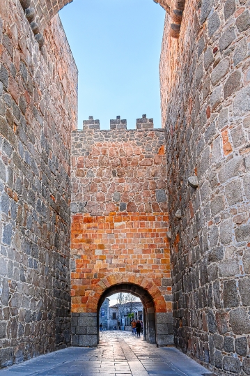 Arched gate leading to a narrow street, part of the city fortifi