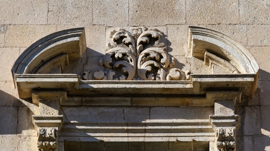 Architectural capital decoration on top of a window in a medieva