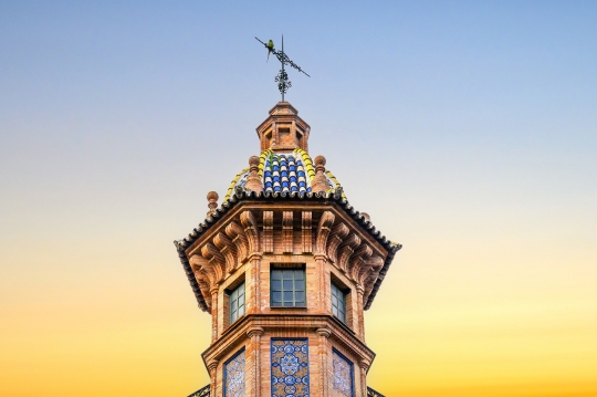 Architectural detail of a decorative tower in the corner of a bu