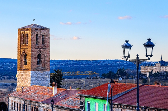 Bell tower of an ancient church and rooftops of other buildings,