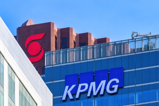 Business signs of KPMG and Scotiabank atop skyscrapers in the fi