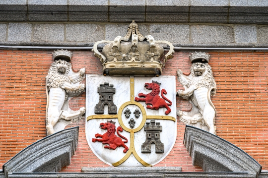 Coat of arms symbol in an ancient facade made with bricks and st