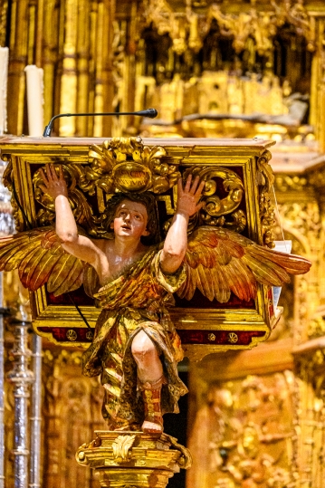 Decorative support sculpture of an angel on an altar stand.