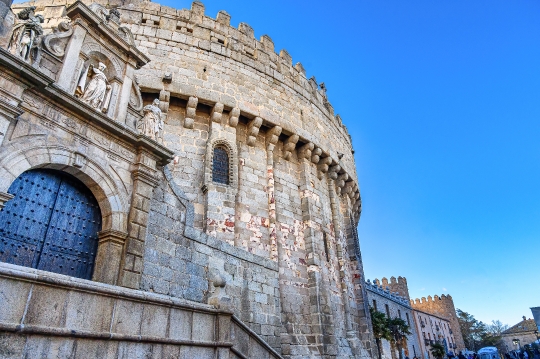 Entrance door and exterior stone wall of a medieval cathedral bu