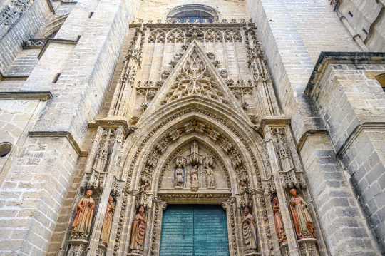 Entrance door in the medieval facade of the cathedral, Seville,