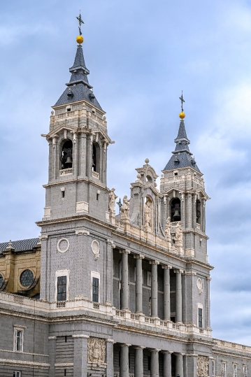 Facade of the Almudena Cathedral against an overcast sky