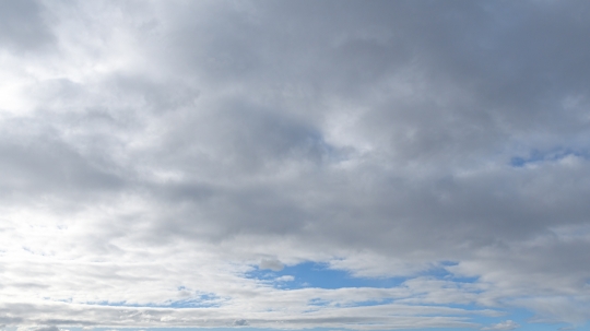 Fluffy clouds covering a morining blue sky