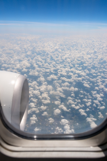 Fluffy clouds seen from an airplane window