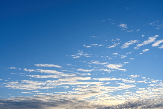 Gold colored light behind clouds of a morning sky