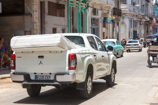 Havana, Cuba, A modern pick-up truck carries a mattress