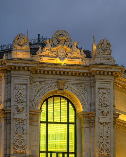 Illuminated arched window of the heritage building Bank of Spain