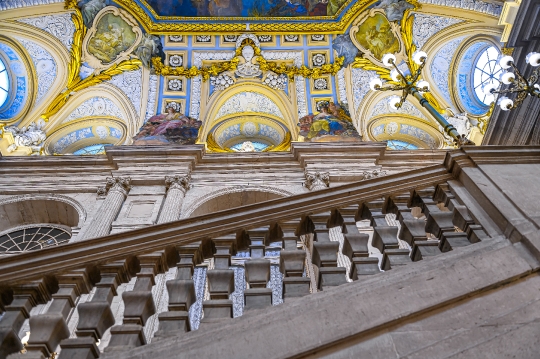 Low angle view of an anciente staircase railing and the ceiling