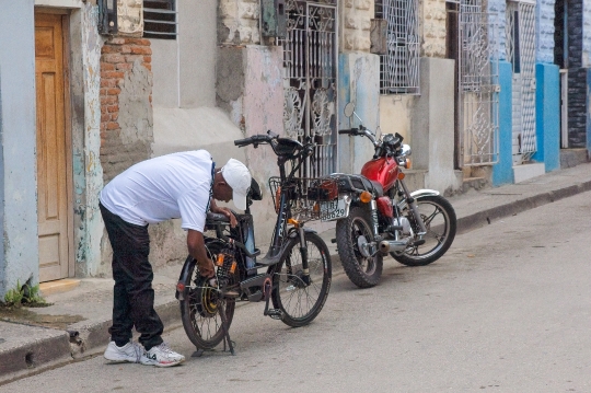 Man Repairing Bicycle