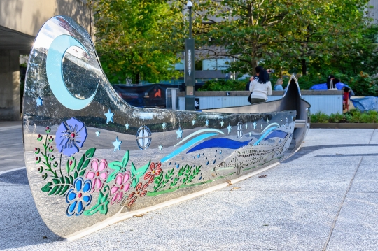 Metal sculpture of a First Nations canoe in the Spirit Garden at