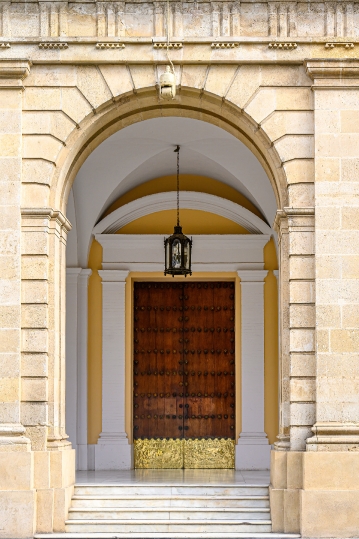 Old door and arch in the facade of a building, Seville, Spain