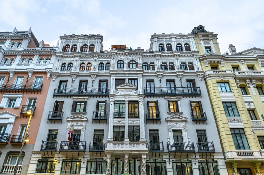 Old facade of an apartment building in Gran Via.