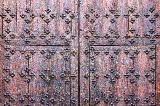 Pattern of decorative rivets on the wooden surface of a medieval