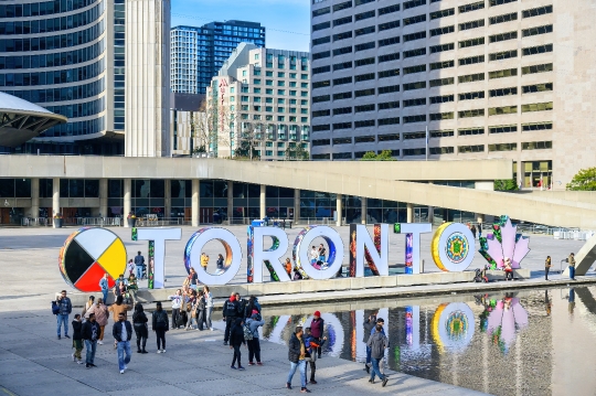 People by the 3D sign in Nathan Phillips Square.