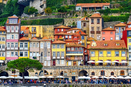 People by the cityscape buildings in the Douro riverfront distri