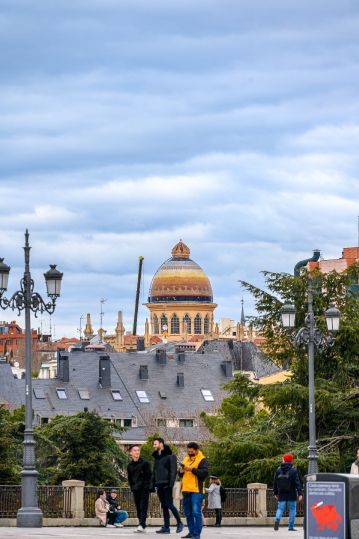 People in a square with the Byzantine dome of the church of Sant