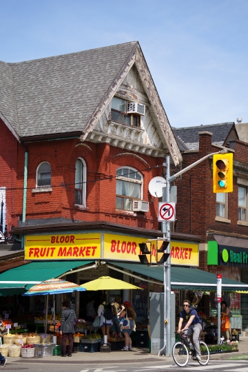 People walk by a Fruit Market