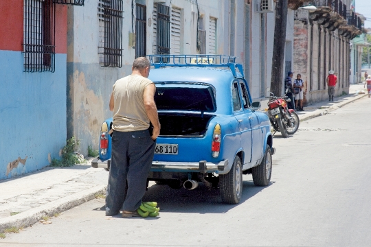 Person by Vintage Car