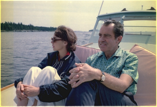 President Nixon,  Julie Eisenhower relax on the prow of the boat