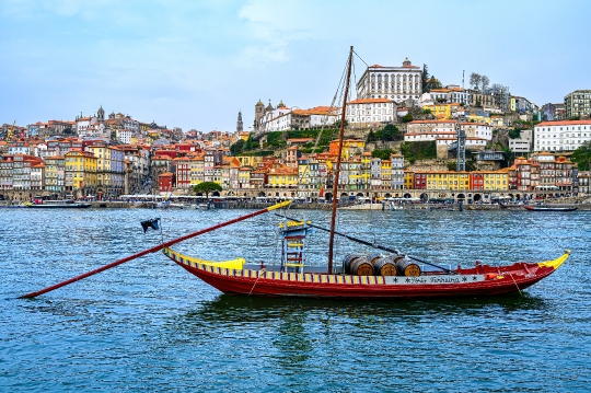 Rabelo boat on the waters of the Douro River, with the cityscape