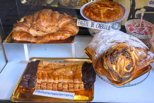 Retail display of traditional giant pastries in a small bakery b