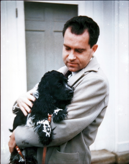 Richard Nixon holds his dog Checkers