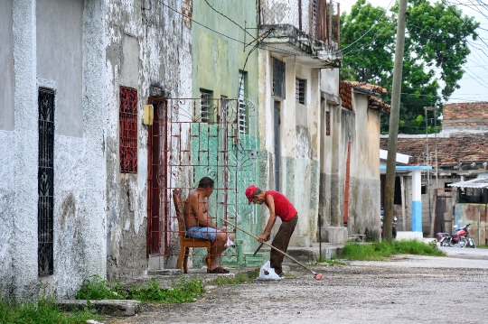 Senior Cuban Man Cleaning Street