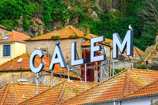 Sign for Calem winery on top of colonial-style tile rooftops of