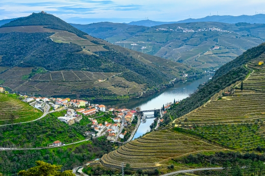 Small town buildings by a bridge over the Douro River.