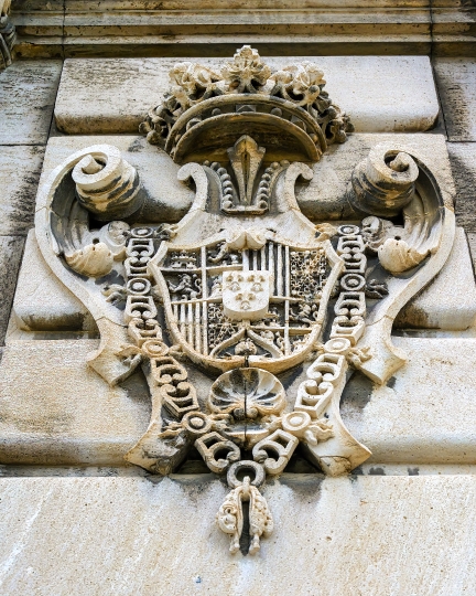 Stone coat of arms in the exterior of the Royal Palace.