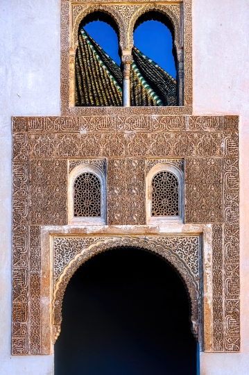 Stone decoration in wall with door and windows