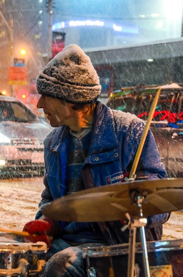 Street Musician in Snow Storm