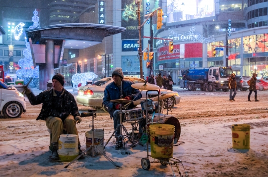 Street Musicians Performing During Snow Storm