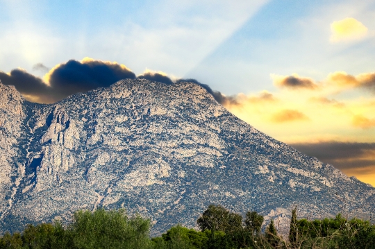 Sunbeams by a semi-arid mountain