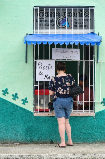 Tourist Buying From House Window