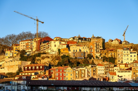 Two cranes in the cityscape or urban skyline, featuring the trad