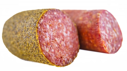 Two pieces of salami sausage isolated on a white background.