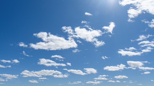 White clouds and sunlight in a blue sky