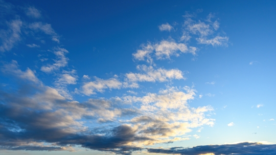 Wide angle of a cloud in a dawn blue sky